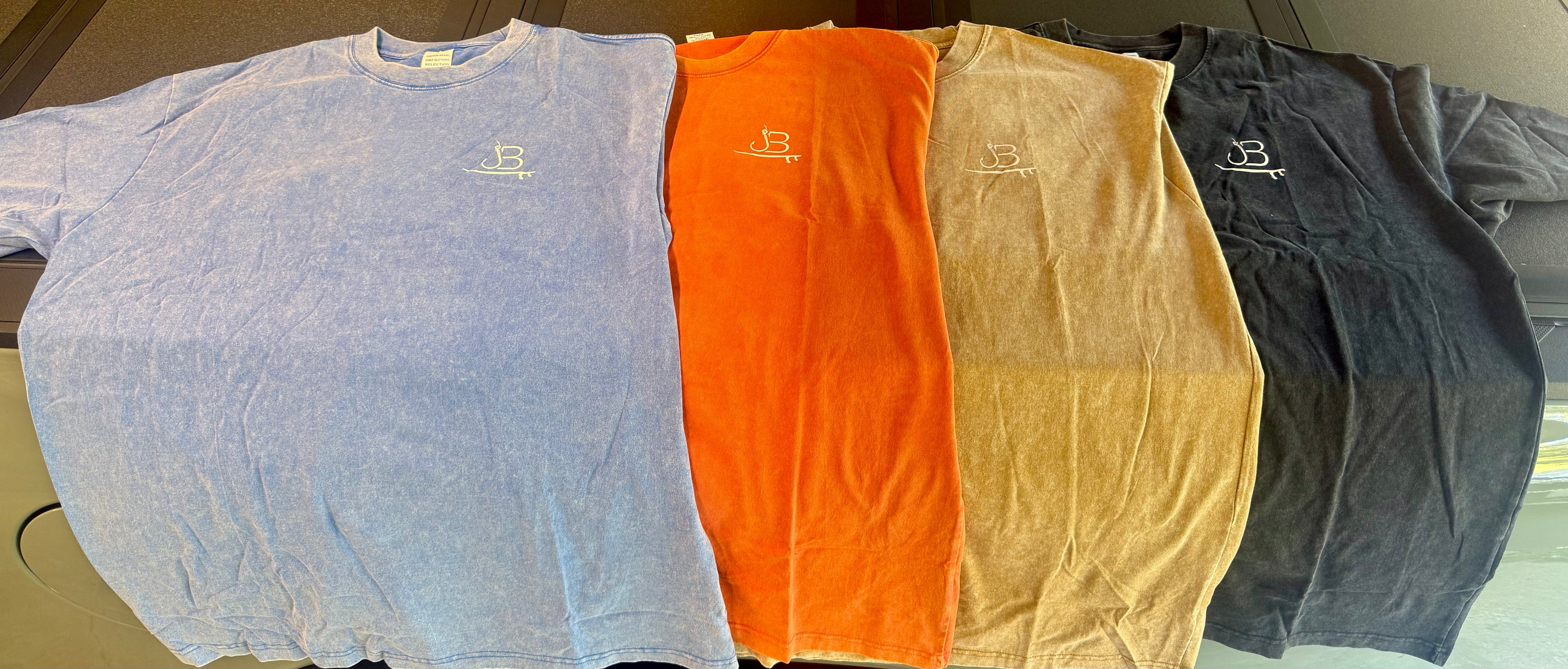 In order L to R (Light Blue, Coral, Desert Tan, Black)